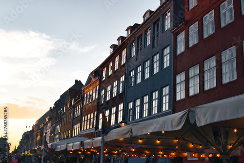 Copenhagen, Denmark - August 30, 2021. Famous Nyhavn pier with colorful buildings and boats in Copenhagen, Denmark