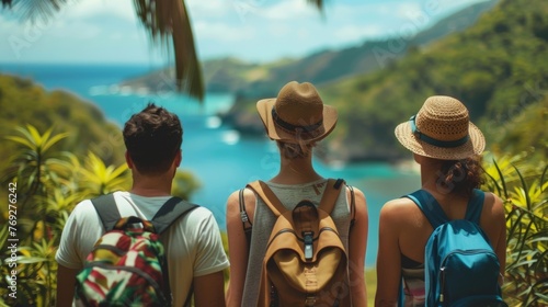 A group of travelers take a moment to appreciate the beauty around them backs to the camera as they admire the pristine island . .