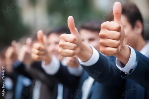 Hands showing thumbs up. Closeup of corporate professionals hand gesturing in the positive or affirmative.