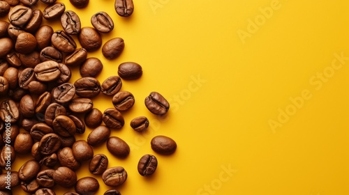 Roasted coffee beans on yellow background. This vibrant image showcases a scattering of aromatic coffee beans on a striking yellow backdrop.