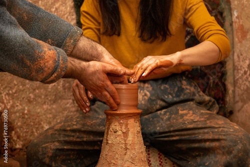 Closeup of two adult people doing pottery during a masterclass in Cappadocia, Turkey