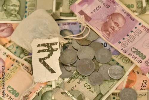 A closeup selective focus of an Indian digital currency with currency notes and Coins