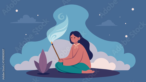  A person sitting in front of a smoking smudge stick used in Native American smudging ceremonies for energy clearing.