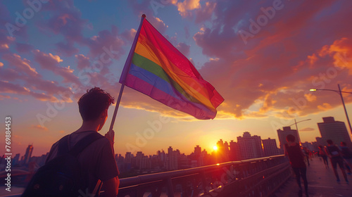 A group celebrating gay pride on a city bridge the rainbow flag contrasting with the urban setting