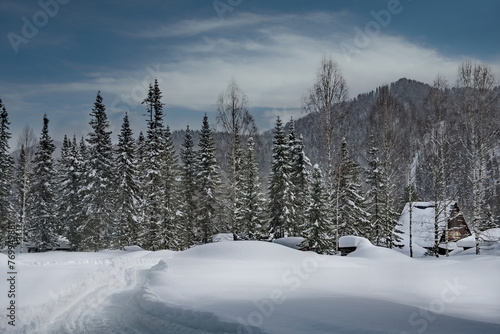 Russia. Kuznetsk Alatau. Winter view of the holiday village of Borisovka among the snow-covered impassable taiga on the banks of the Tom River.