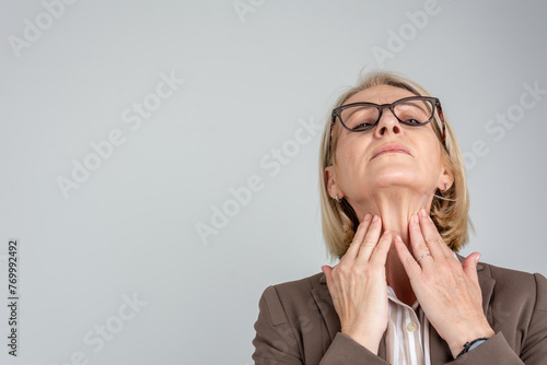 Woman thyroid gland control. Senior lady sweeping the laryngeal, laryngitis, goiter or Hypothyroidism. Disorder of the endocrine system. Hashimoto’s Thyroiditis, Lymphocytic Thyroiditis.