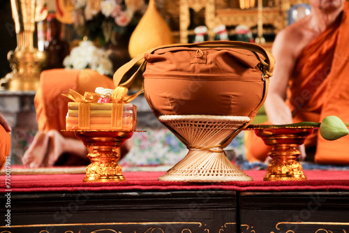 monk's alms bowl , candle and lotus flower on golden tray in ordination ceremony to be monk tradition in Bangkok Thailand Buddhism temple on 11 June 2017