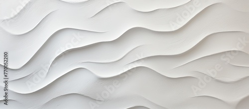 A close up of a grey slope landscape with aeolian landform patterns resembling waves on a white wall, creating a serene and unique aesthetic