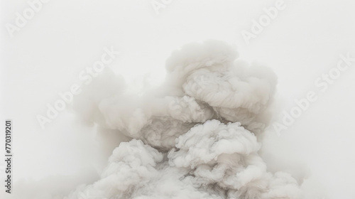 A white cloud of smoke is billowing into the sky. The smoke is thick and grey, and it seems to be coming from a fire. Concept of danger and destruction
