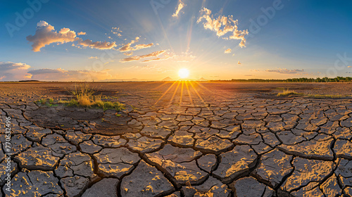 A parched cracked earth landscape under a scorching sun illustrating severe drought conditions.