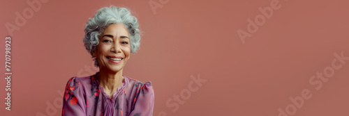 Stylish senior well-groomed African American woman derssed in fashionable expensive clothes on bright pink background, copy space, web banner