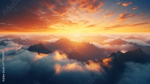 Beautiful golden sunset above cloud with sun shinning on horizon and mountain.