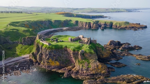 aerial photograph of the cliffs and sea with castle on top
