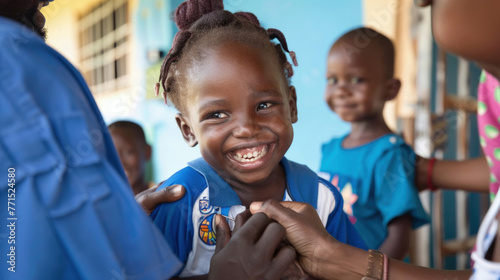 A young girl is smiling while holding her hand over her shoulder in a joyful gesture