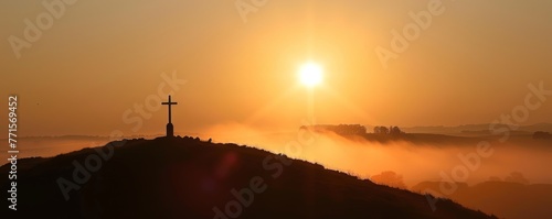Soft light gently touches the Christian cross on the hill.