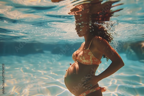 Underwater pregnant woman wearing swimsuit in deep pool