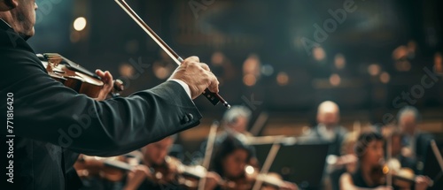 Performing symphony orchestra background, close-up of hands of conductor.