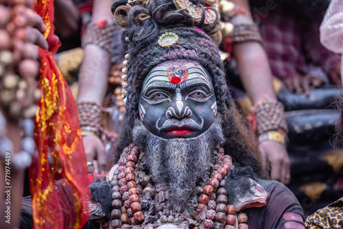 Masan Holi, Portrait of an male artist act as lord shiv with dry ash on face and body during celebrating the holi festival as tradition at Manikarnika ghat in varanasi, India.