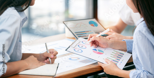 diverse coworkers working together in boardroom, brainstorming, discussing and analyzing and planning business strategy..