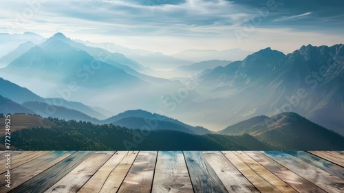 Misty mountains with morning light on wood deck - A serene dawn breaks over mist-covered mountains, seen from a weathered wooden deck viewpoint