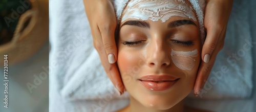 A young woman undergoing a facial mask treatment at a spa. A beautician is carefully applying the mask to her face, enhancing her skincare routine.