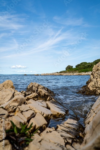 Vertical shot of a beautiful sunny rocky shoreline in Croatia