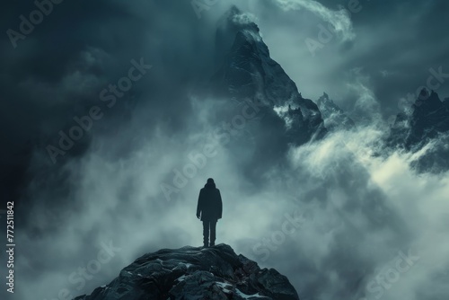 Lone figure standing on a rocky peak surrounded by mist and dramatic mountains, evoking solitude and adventure. Concept of exploration, nature, and mystery. 