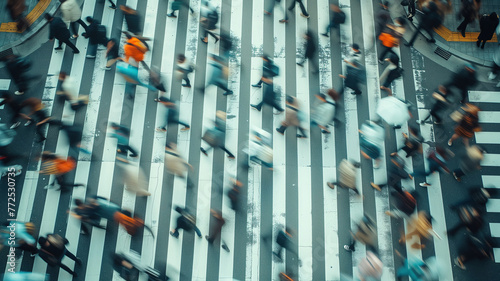 Aerial view of a crossroads in a big city with people crossing it, blur effect