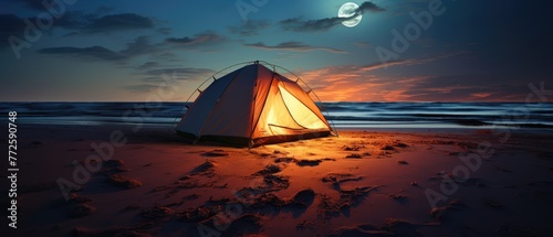 Illuminated Tent on a Beach Under Moonlight