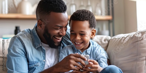 Father and son spending family time together - fatherhood and parenting concept for father's day with dad and child