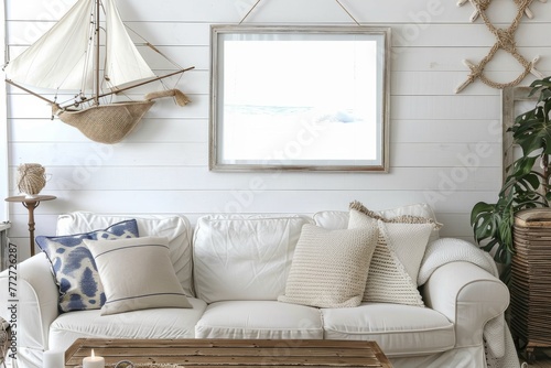 White couch in a living room with sailboat wall decor