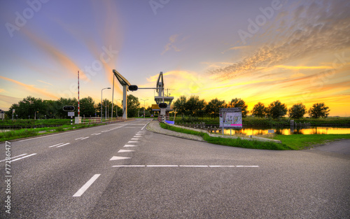 Dutch drawbridge named "Schoorldammerbrug" at sunset.