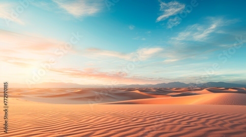 Sunrise over sand dunes in a desert landscape