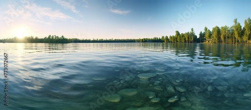 Large panorama of green lake, blue caste at dawn, sunlight shadows on the water