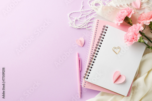 Mother's Day musings: notebook, carnations, and a pen on a lilac surface, perfect for writing heartfelt notes