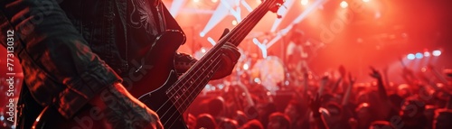 Engaging stock image highlights bass guitar, fingers plucking strings, spotlighting the essential rhythm element of a rock group.