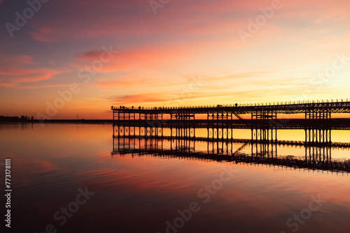 Captivating sunset scenery unfolds at The Rio Tinto Pier (Muelle de Rio Tinto) in Huelva, Andalusia, Spain