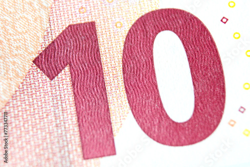 Close-up of a 10 euro banknote fragment on the reverse side, showing the denomination - number 10 . Macro photography.