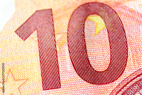 Close-up of a 10 euro banknote fragment on the obverse side, showing the denomination - number 10 . Macro photography.