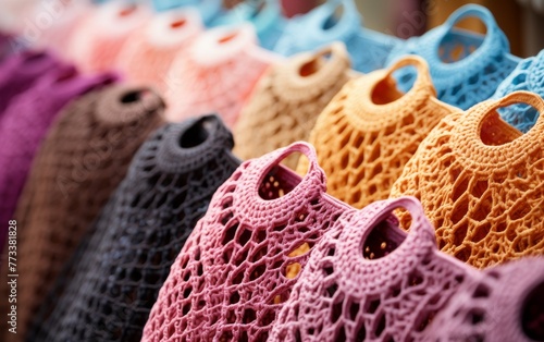 A vibrant row of crocheted purses arranged neatly on a wooden table