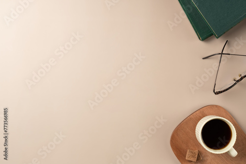 Book, glasses, candle, with cup coffee on beige background. Leisure concept, reading a book. Flat lay, top view