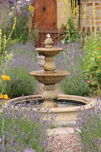 An Ornamental Fountain In a Colourful Country Garden.