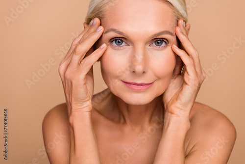 Photo portrait of gorgeous attractive senior older woman touch face smooth soft shoulders off isolated on beige color background