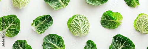 Pattern created with fresh cabbage leaves against a clean white background