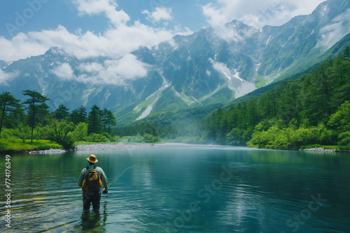 Man Fishing in a Lake Surrounded by High Mountains.