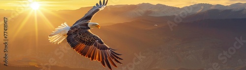A majestic bald eagle soaring in the golden light of sunset with a mountainous landscape stretching out below.