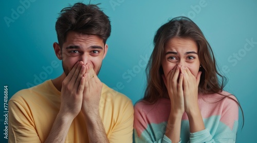 Couple sneezes together in studio on black background