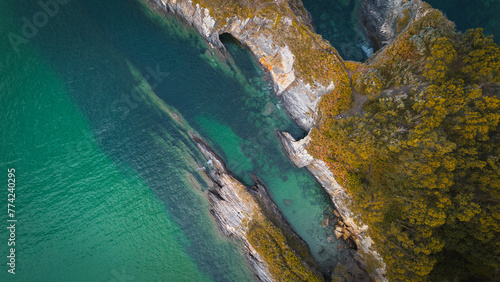 Aerial view of the coast with turquoise water and sharp cliffs in Galicia