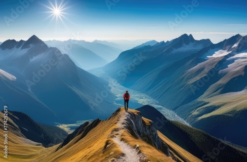 A man stands on the edge of a mountain in a chic mountain landscape in summer