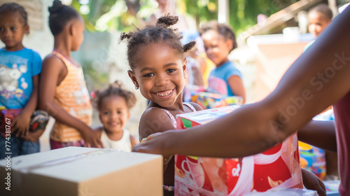 Conference attendees distribute school supplies to children in a low-income community. The joyful exchange is captured in bright daylight, with the children’s smiling faces lit up